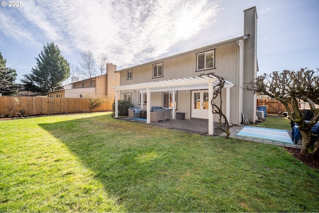 rear view of house with french doors, a patio, a lawn, a pergola, and a fenced backyard