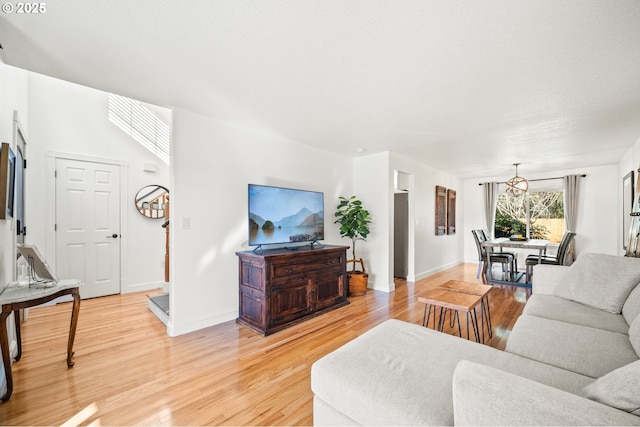 living room featuring baseboards and light wood-style floors