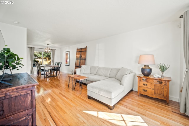 living room with light wood-type flooring and baseboards