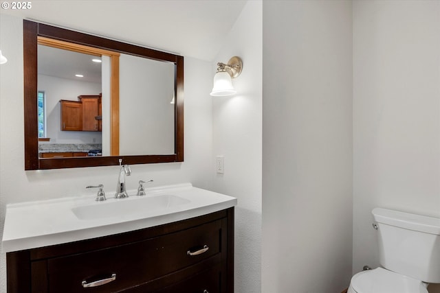 bathroom featuring toilet and vanity