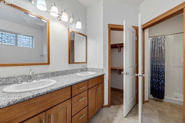 bathroom featuring a shower with shower curtain, tile patterned flooring, and vanity