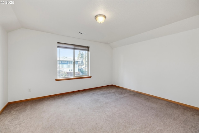 spare room with lofted ceiling and carpet