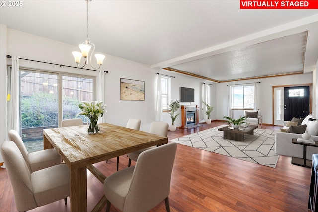 dining space featuring a notable chandelier and wood-type flooring