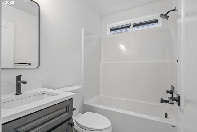 bathroom with washtub / shower combination, vanity, and toilet