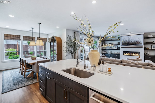 12703 NE 58th Ave, Vancouver, WA 98686 - kitchen with a sink, light countertops, dark wood-style floors, a glass covered fireplace, and recessed lighting