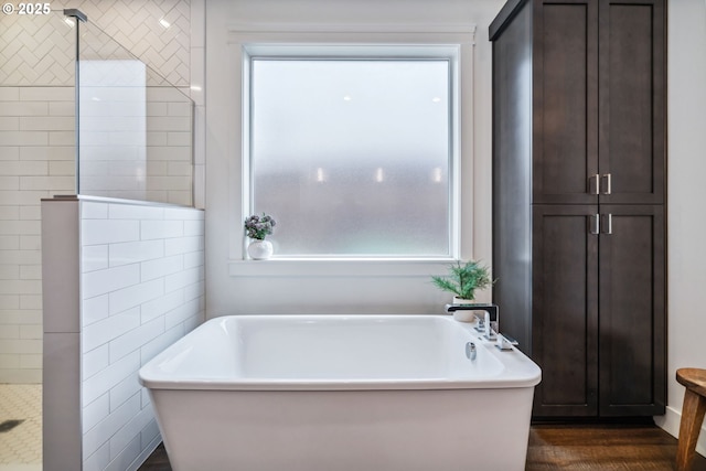 12703 NE 58th Ave, Vancouver, WA 98686 - bathroom featuring a soaking tub, wood finished floors, and tiled shower
