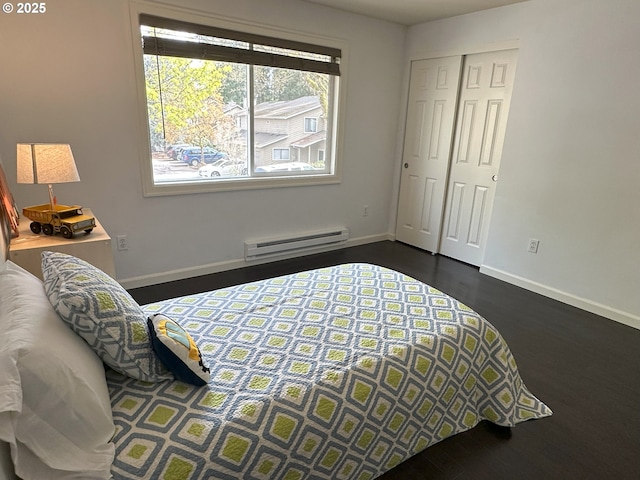 29640 SW Volley St Unit 39, Wilsonville, OR 97070 - bedroom with a baseboard heating unit, baseboards, dark wood-style flooring, and a closet