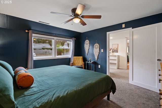 bedroom featuring ceiling fan, carpet flooring, visible vents, and baseboards