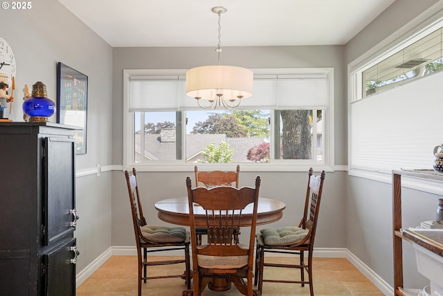 dining area with healthy amount of natural light, baseboards, and light tile patterned floors
