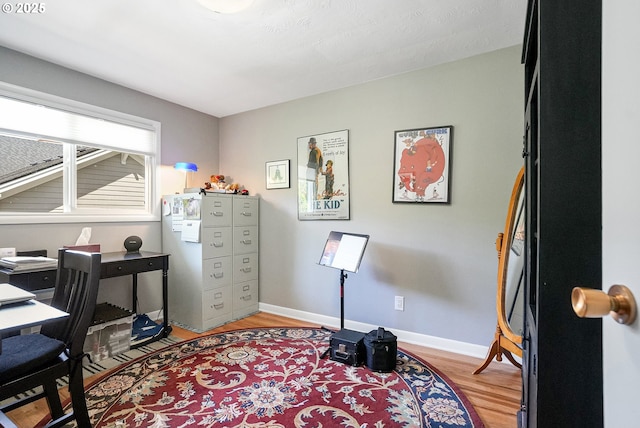 office area featuring light wood-style floors and baseboards