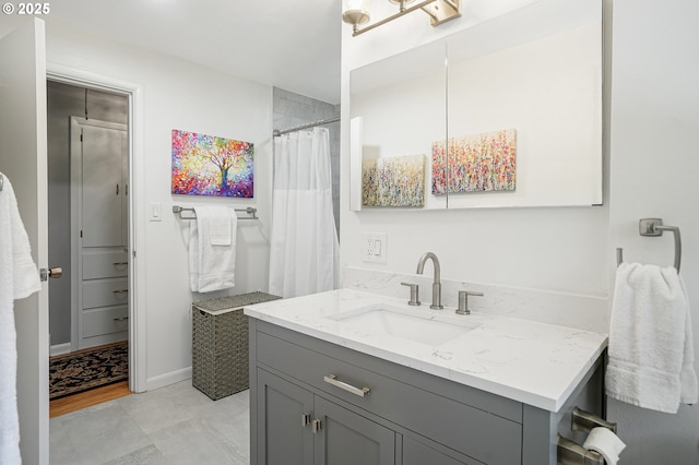 bathroom featuring vanity and curtained shower