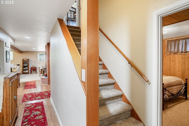 stairs featuring wood finished floors