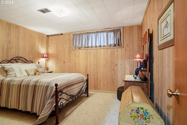 bedroom with carpet floors and wood walls