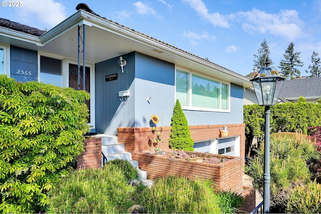 doorway to property with brick siding