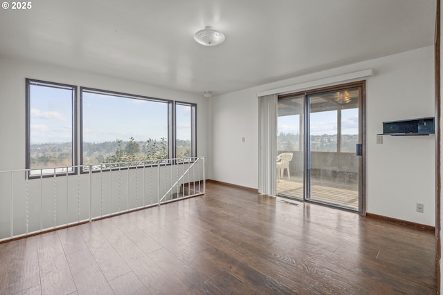 empty room with hardwood / wood-style floors