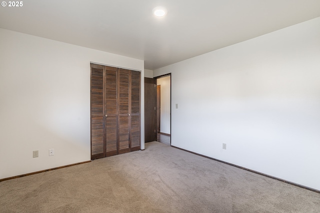 unfurnished bedroom with a closet and carpet flooring