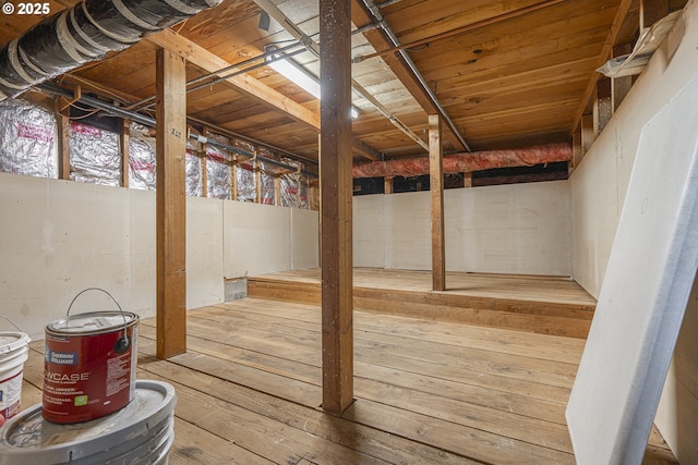 basement with hardwood / wood-style floors