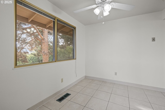 empty room with light tile patterned flooring and ceiling fan