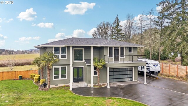 view of front of house featuring a garage, a balcony, french doors, and a front lawn