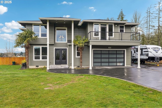 view of front of property with french doors, a balcony, a garage, and a front lawn