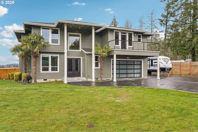 view of front of house with aphalt driveway, a balcony, fence, french doors, and a front lawn