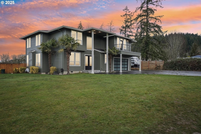 view of front of home with driveway, a garage, a lawn, a balcony, and crawl space