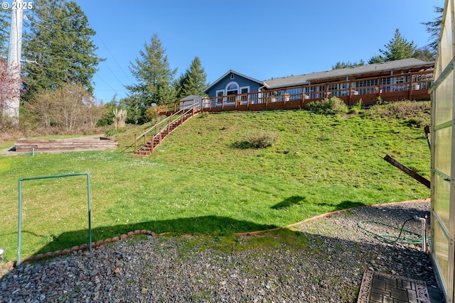 view of yard with stairway and a deck