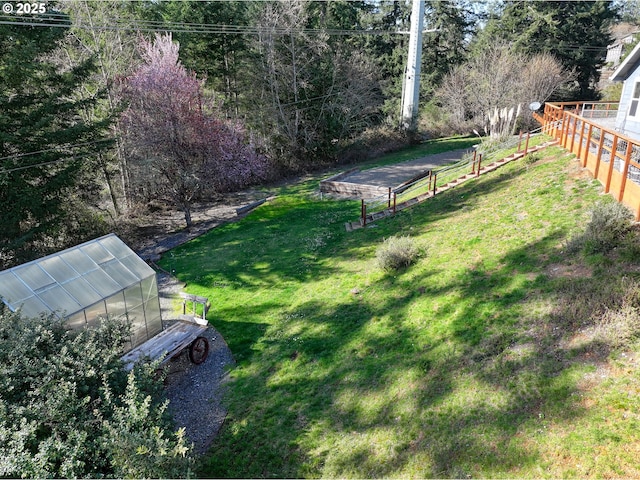 view of yard featuring an exterior structure, an outdoor structure, and fence