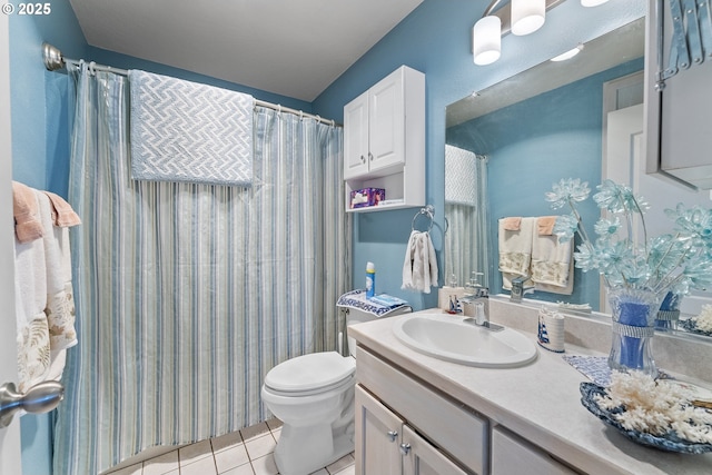 full bathroom featuring curtained shower, toilet, vanity, and tile patterned flooring