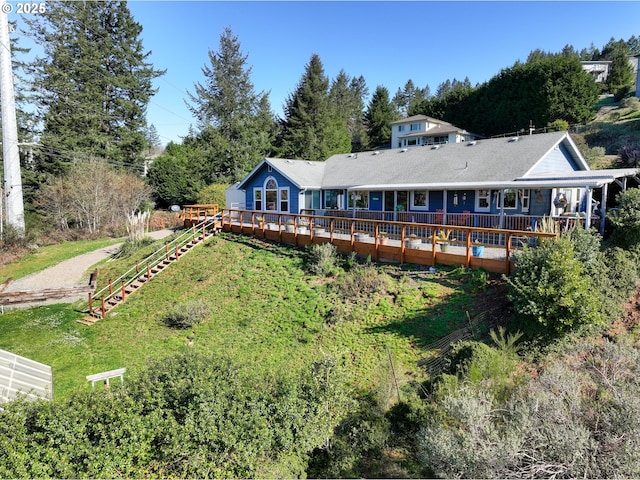 back of property featuring a lawn and a wooden deck