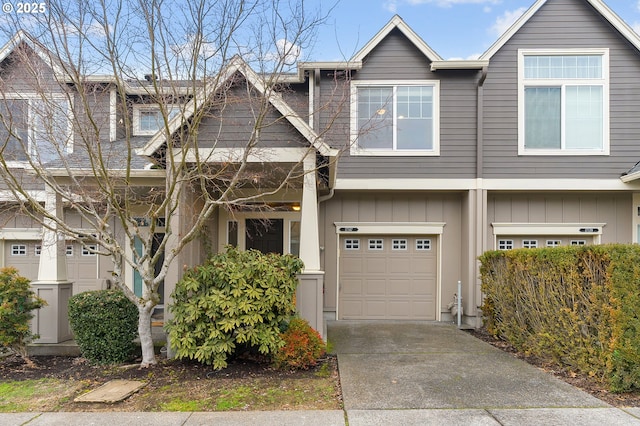 view of property featuring a garage, driveway, and board and batten siding