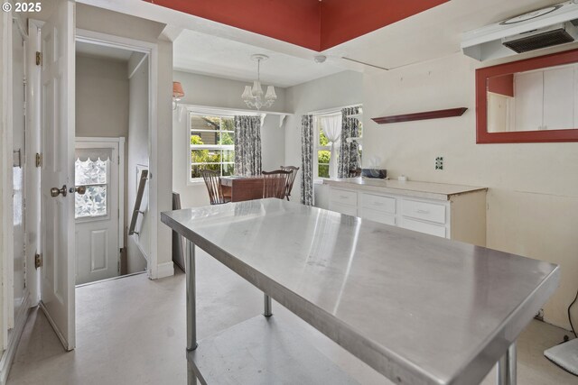 bathroom featuring stacked washer and clothes dryer, baseboards, and a sink