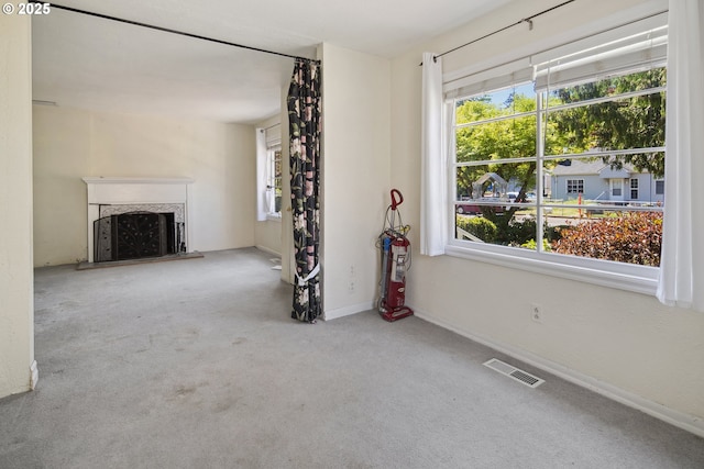 empty room with carpet floors, baseboards, and ceiling fan