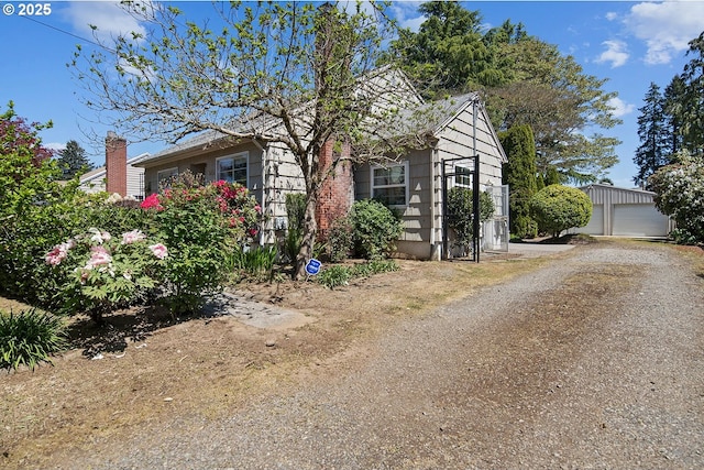 obstructed view of property with an outbuilding and a detached garage