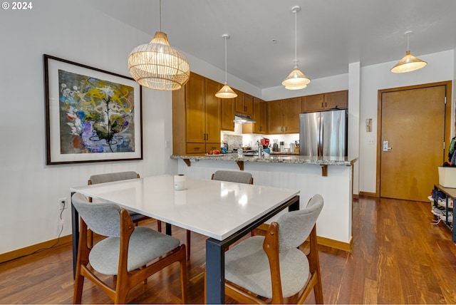 dining room featuring dark wood-type flooring and baseboards