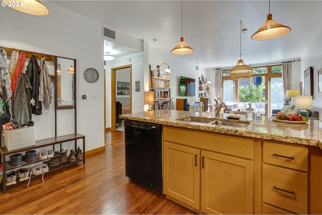 kitchen featuring visible vents, wood finished floors, light stone countertops, a sink, and dishwasher
