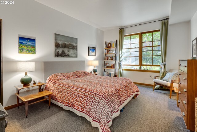 carpeted bedroom featuring baseboards