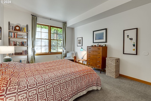 carpeted bedroom featuring baseboards
