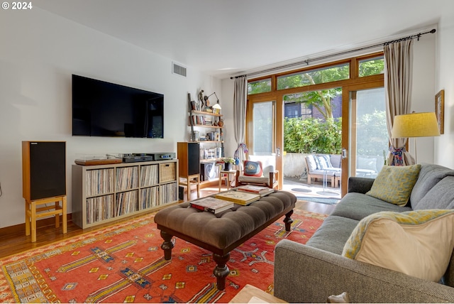 living room with visible vents and wood finished floors