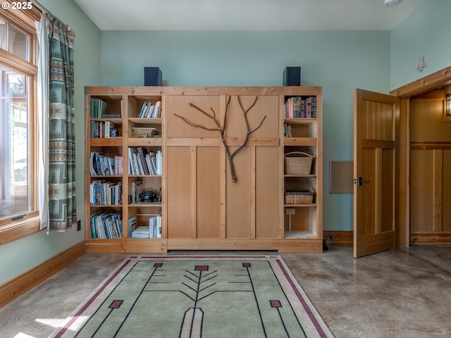 interior space featuring baseboards and a healthy amount of sunlight