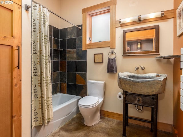 full bath with a sink, baseboards, toilet, and shower / bath combination with curtain