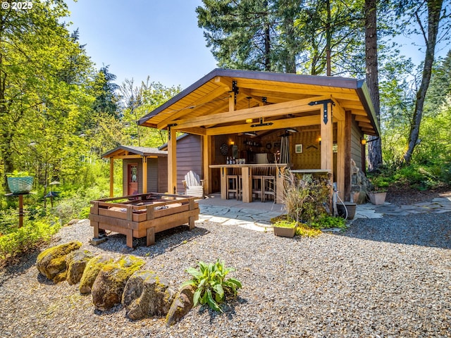 back of house featuring outdoor dry bar