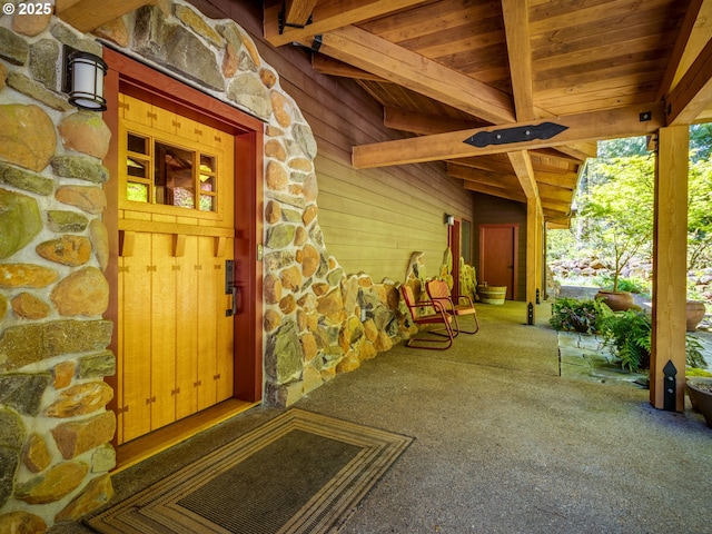 doorway to property with stone siding