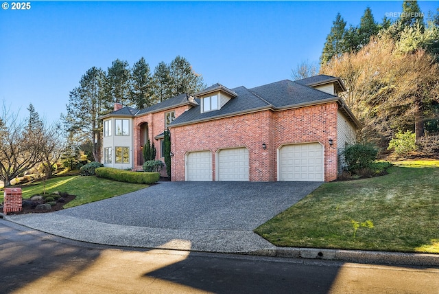 view of front of home with a front yard and a garage