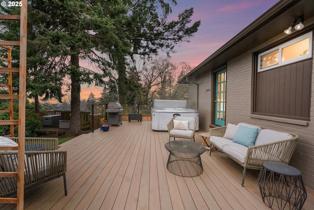 wooden deck with an outdoor hangout area, area for grilling, and a hot tub