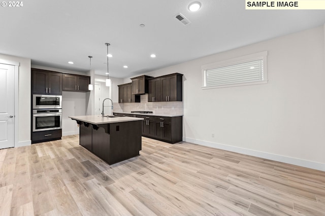 4206 NE 188th St Lot 328, Vancouver, WA 98686 - kitchen with light wood finished floors, visible vents, light countertops, tasteful backsplash, and appliances with stainless steel finishes