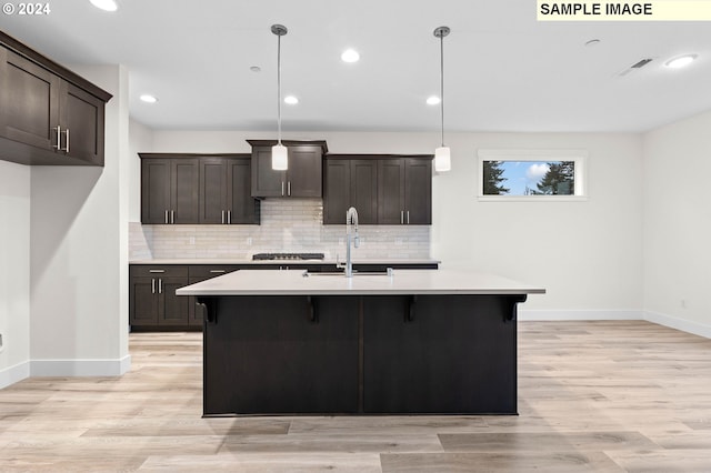 4206 NE 188th St Lot 328, Vancouver, WA 98686 - kitchen with baseboards, a sink, dark brown cabinetry, light countertops, and tasteful backsplash