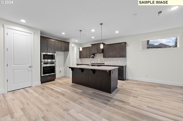 4206 NE 188th St Lot 328, Vancouver, WA 98686 - kitchen featuring dark brown cabinets, visible vents, light countertops, appliances with stainless steel finishes, and decorative backsplash