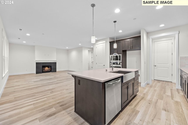 4206 NE 188th St Lot 328, Vancouver, WA 98686 - kitchen with light wood-style flooring, light countertops, dark brown cabinets, and appliances with stainless steel finishes