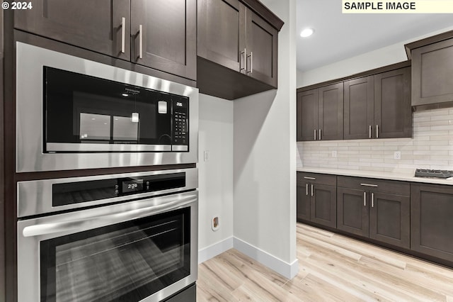 4206 NE 188th St Lot 328, Vancouver, WA 98686 - kitchen featuring baseboards, light wood-style flooring, appliances with stainless steel finishes, and dark brown cabinetry